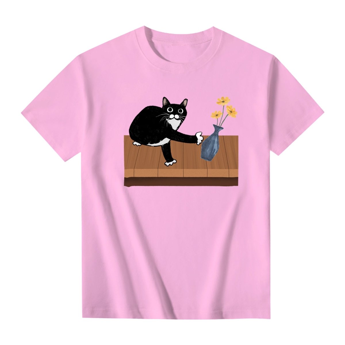 Playful pink T-shirt showing a cute cartoon cat with wide eyes trying to push a vase off the table, a fun gift for cat lovers