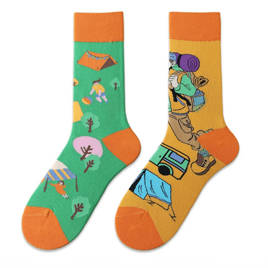 Mismatched camping socks with colorful outdoor design – one sock with campsite and tents, the other with hiker and backpack, unisex novelty gift