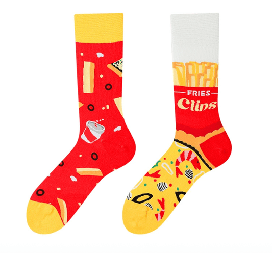 A pair of mismatched socks featuring fries, shrimps on one and sliced pizza and cola design on the other.